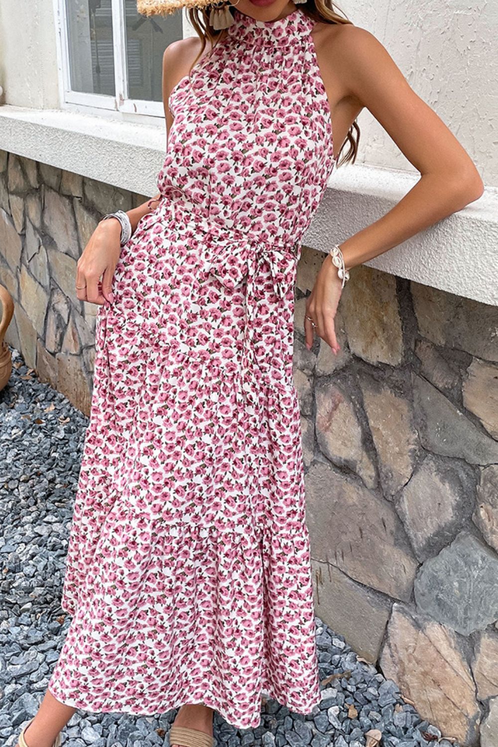 Woman wearing pink floral print tiered midi dress