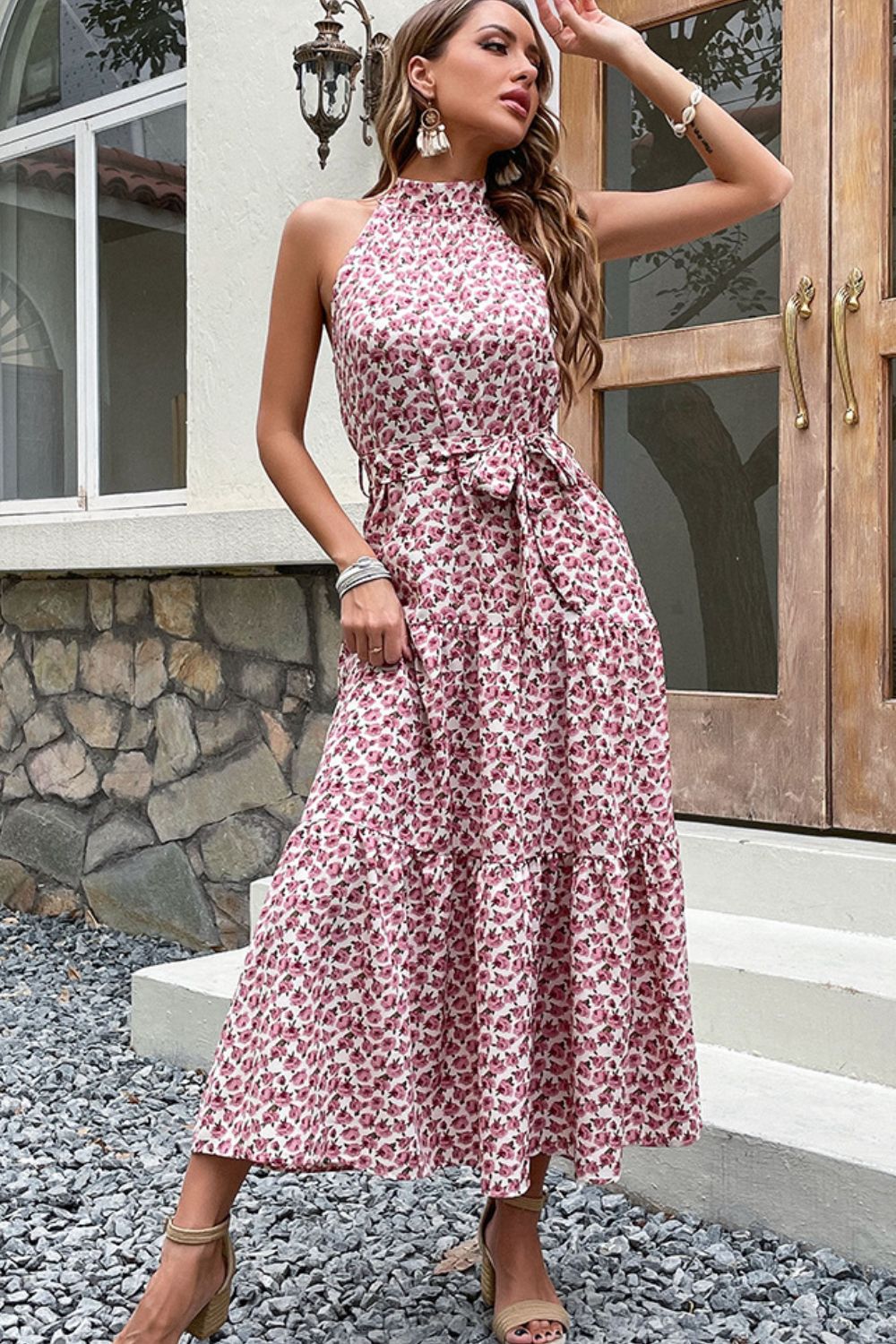 Woman wearing pink floral print tiered midi dress